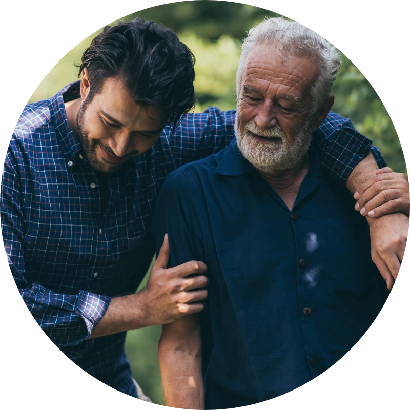 A young man has his arm around his father while they walk together.